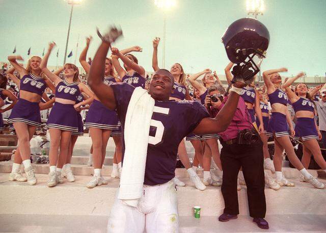 Nov. 20, 1999: TCU tailback LaDainian Tomlinson celebrates breaking the NCAA record for most yards rushing in a single game during the school song after their win over UTEP at Amon G. Carter Stadium.